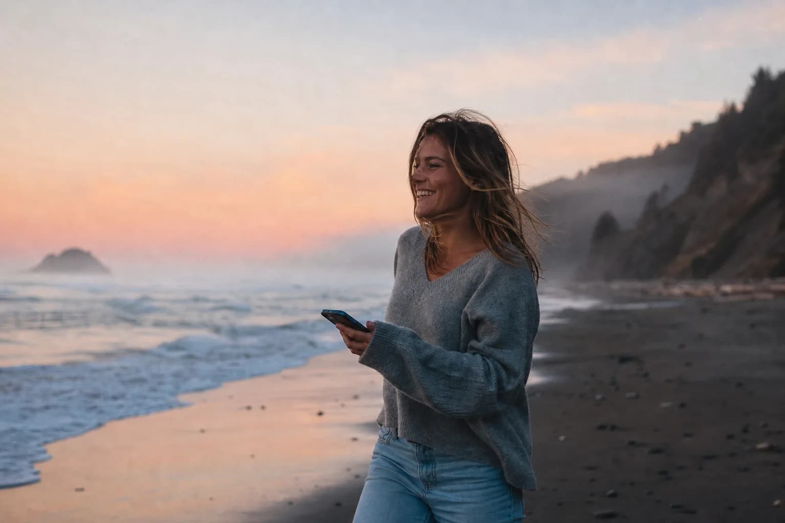 Walking along a misty shoreline at sunrise